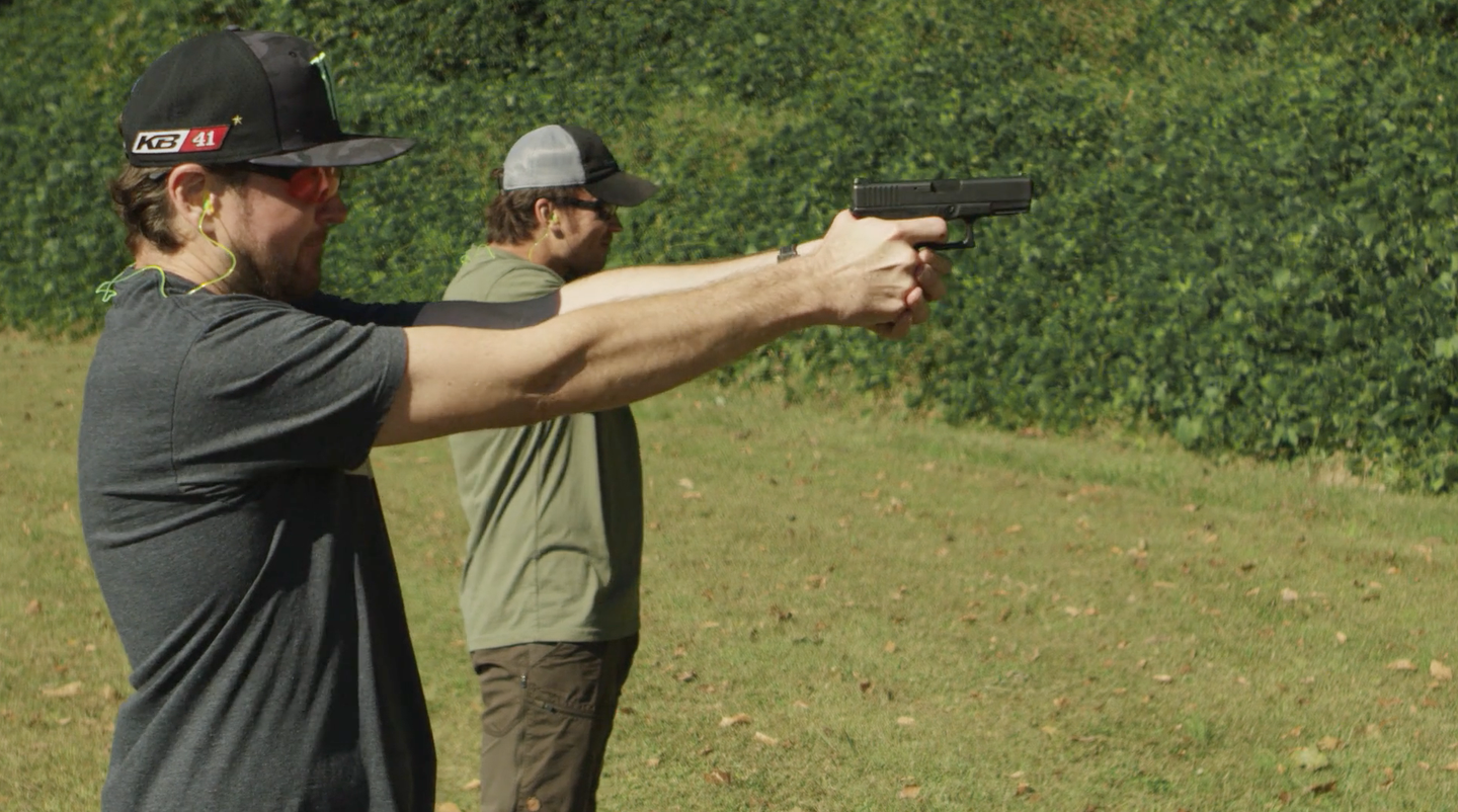 Busch and Glover training with pistols.