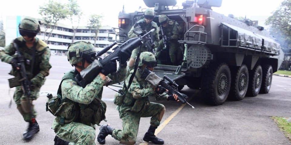 Singaporean soldiers dismount a Terrex Infantry Carrier Vehicle, February 23, 2013.