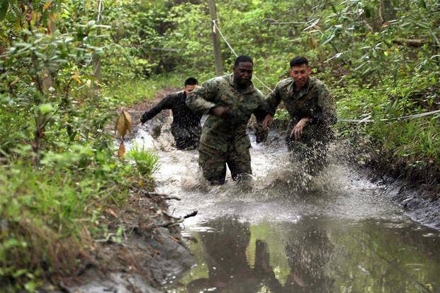 Marines with Combat Logistics Regiment 2 splash their way through one of the many mud puddles during an endurance course at Camp Lejeune, N.C., April 22, 2016.