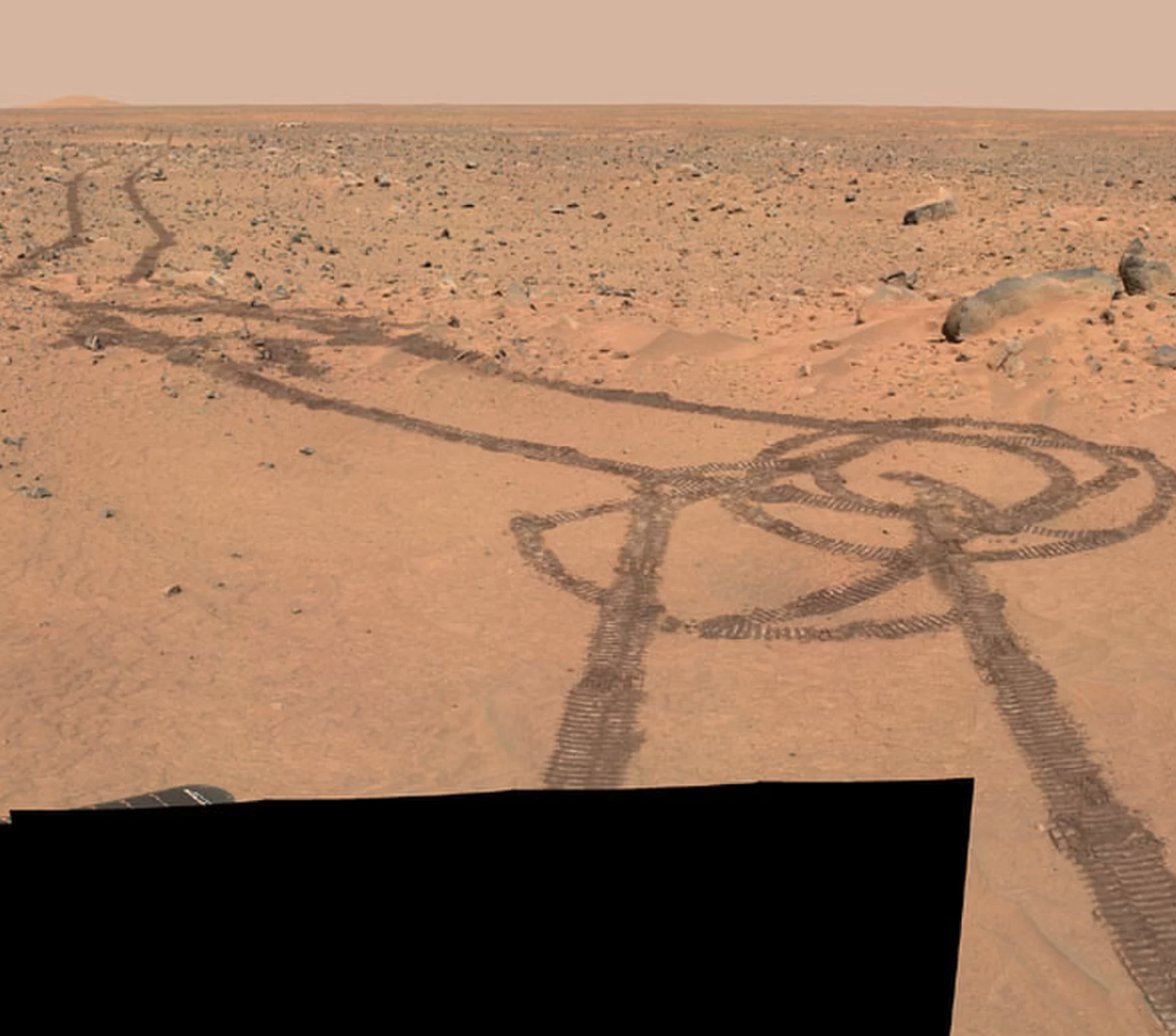 NASA's Spirit Mars rover created these tracks shortly after touching down in 2004 to execute a turn, not deface the surface like a Marine Corps bathroom.