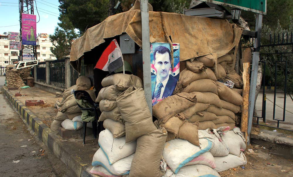 A poster of Bashar al-Assad at a checkpoint on the outskirts of Damascus