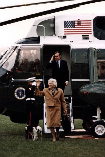 President Bush, Mrs. Bush, and Millie leave Marine One.