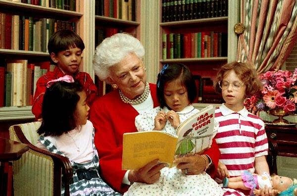 Mrs. Bush reads to children in the White House Library.