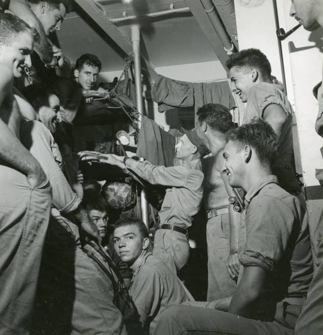 Ernie Pyle visiting with Marines aboard USS Charles Carroll (APA-28) while enroute to Okinawa /u00a0Date: March 20, 1945