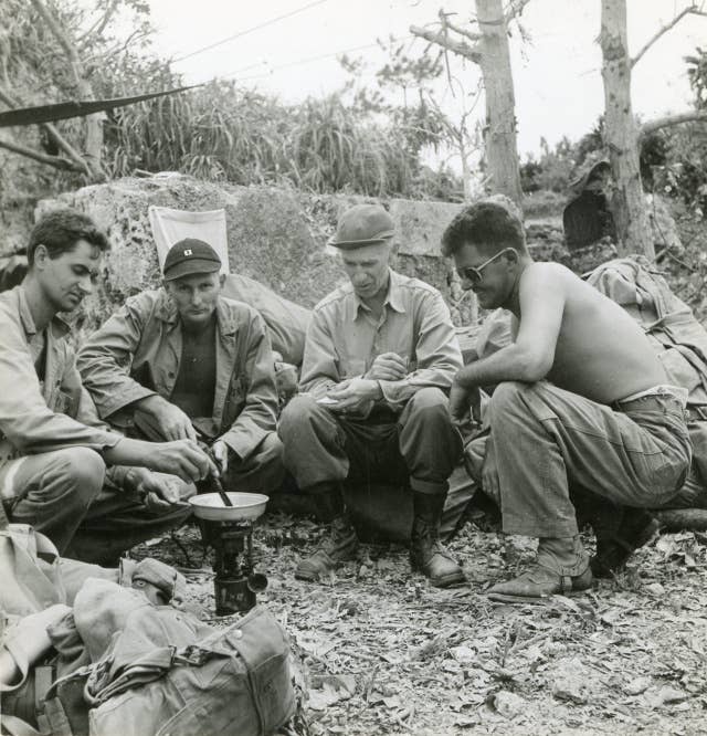 Caption: L to R; Edward P. Krapse, Lt. Arlington Bensel Jr., Ernie Pyle, and Cpl. Edward M. Wrenne.