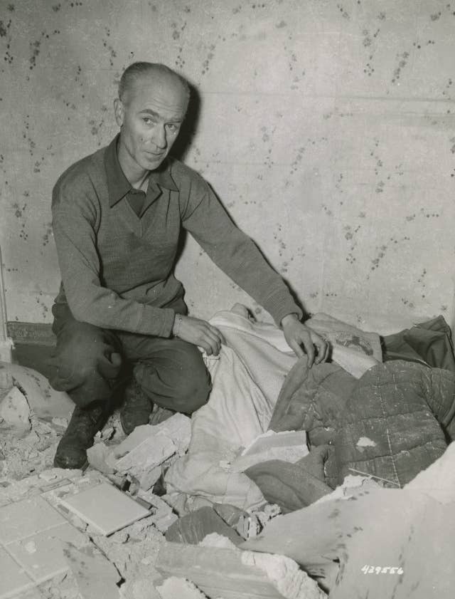 Bomb that hit PRO today also hurt some of the war correspondents, among whom was Ernie Pyle. He suffered a slight cut on the face and is here looking at his bed from which he had just left to watch the bombing, when the roof fell on it. Nettuno Area, Italy.