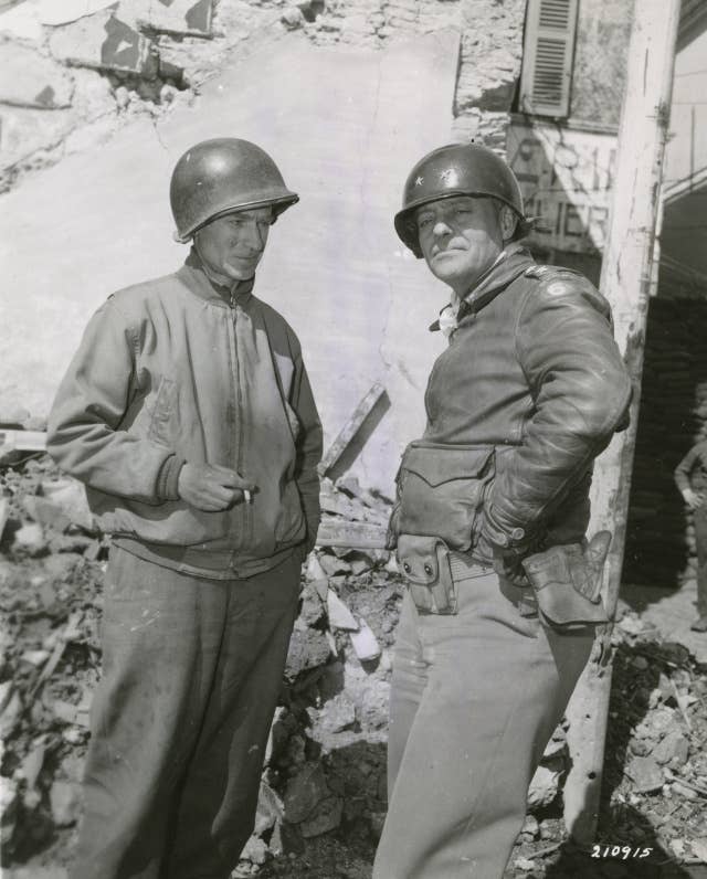 At Nettuno, Italy, Ernie Pyle, war correspondent, and Major General Lucian Truscott, stand in front of Corps Headquarters.