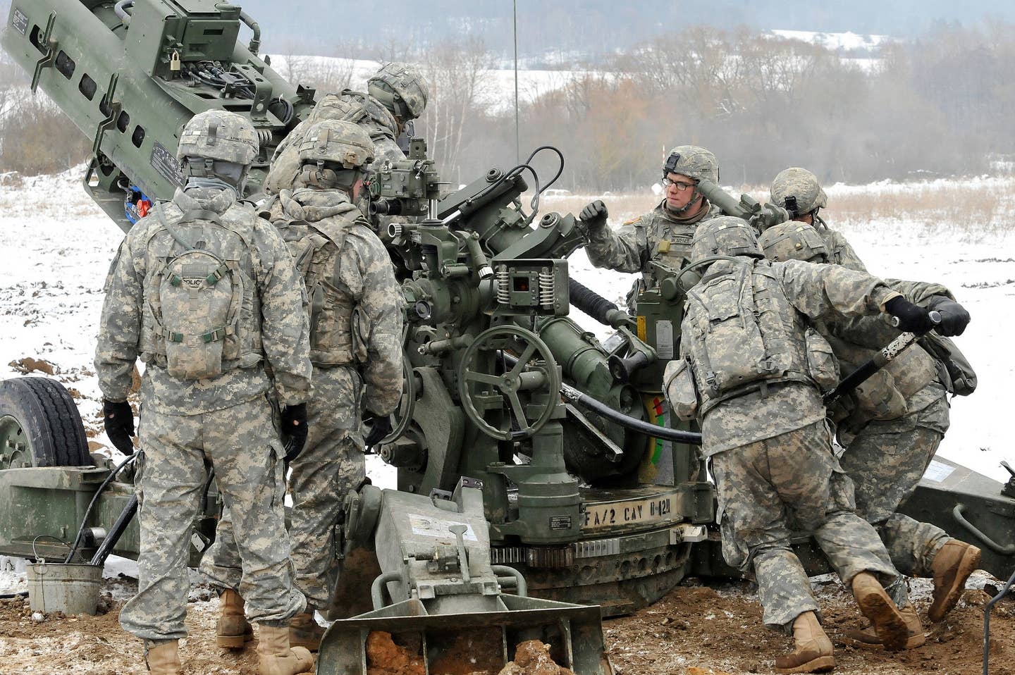 Soldiers load an M777u00a0155mm howitzer