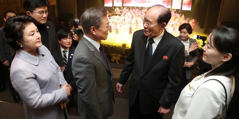 Moon (center, in the gray suit) talks with Kim Yong Nam, North Korea's nominal head of state, and Kim Yo Jong, Kim Jong Un's sister, in Seoul in February 2018.