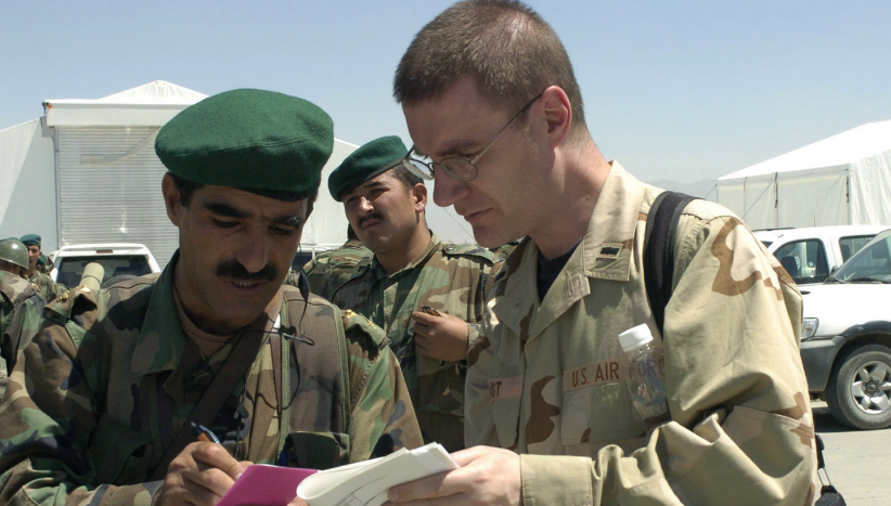 Afghan soldiers communicating with a member of the US Air Force