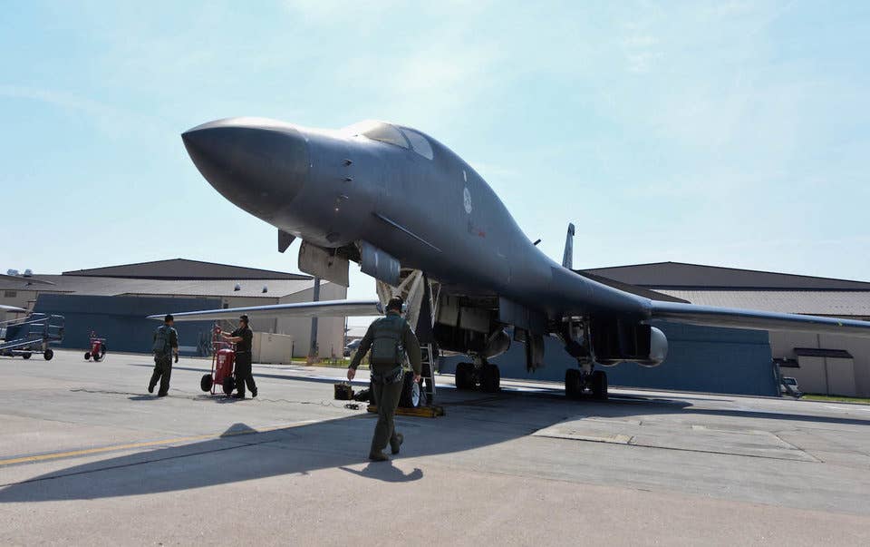 Aircrew members perform preflight checks on a B-1B Lancer as part of a standoff-weapons-integration exercise at Ellsworth Air Force Base, South Dakota, August 13, 2014.