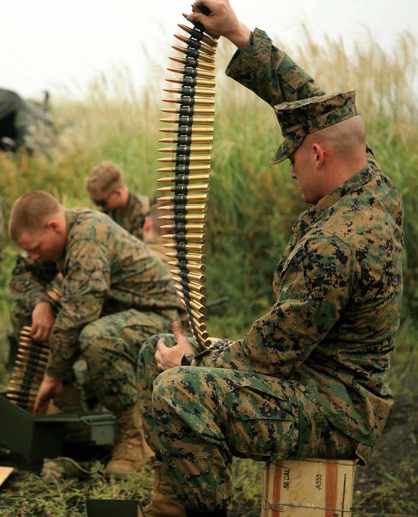 Ammunition for the M2 .50 caliber machine gun is prepared as Marines with Headquarters Battery, 3rd Battalion, 12th Marine Regiment, 3rd Marine Division, III Marine Expeditionary Force, prepare for their first day of firing crew-served weapons at the East Fuji artillery range Sept. 12.