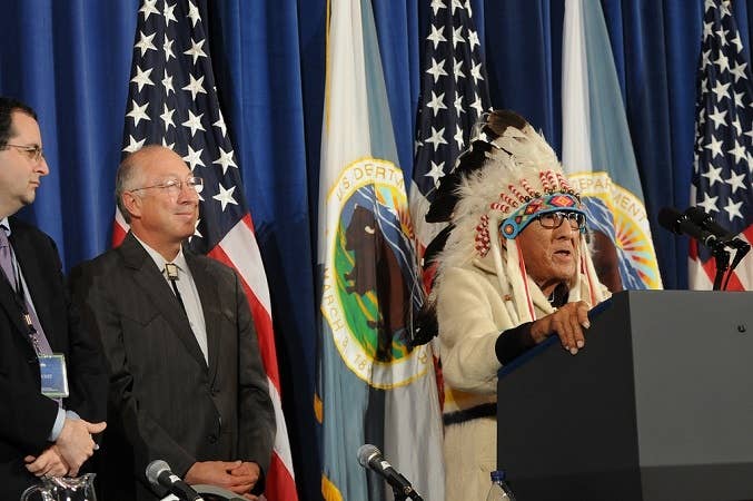 Chief Joe Medicine Crow speaking in traditional Crow clothing