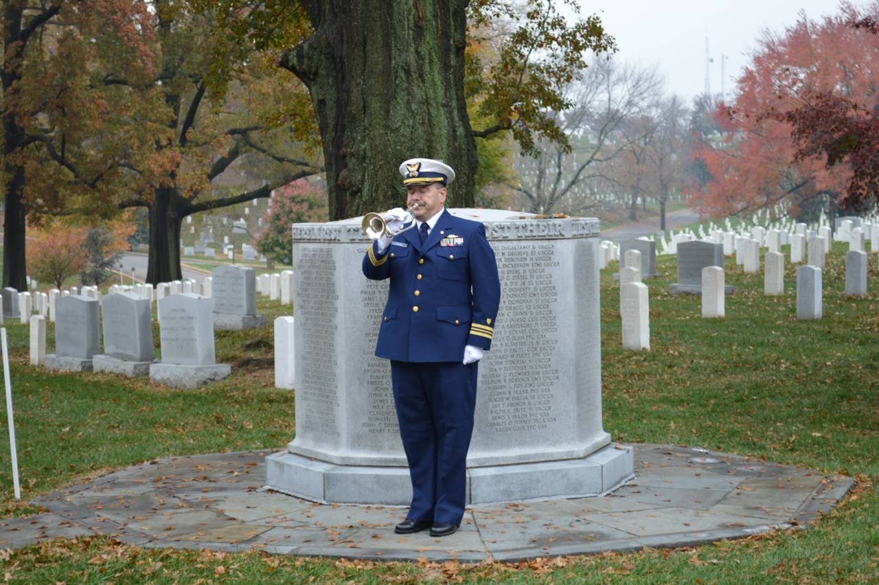 Retired Coast Guard officer Richard Stoud plays taps at the Serpens Memorial in November 2013.