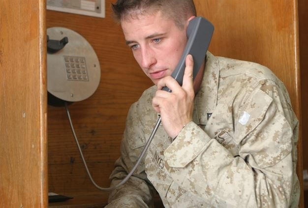 Lance Cpl. Eric W. Hayes makes a phone call to his mother from the phone center at Camp Buehring, Kuwait. (Photo by Gunnery Sgt. Mark E. Bradley)