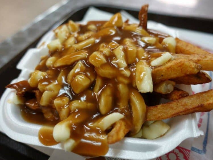 Poutine is a popular Canadian dish consisting of fries topped with cheese curds and drenched in gravy.