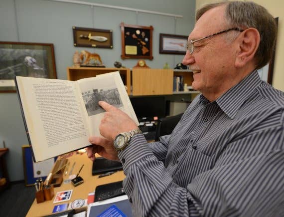 Johnie Webb points to a photo of him published in a book on U.S.-Vietnam diplomatic relations after the war inside his office at Joint Base Pearl Harbor-Hickam, Hawaii, March 13, 2018.