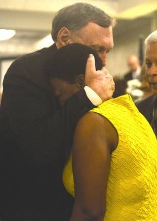 Johnie Webb consoles a grieving family member.