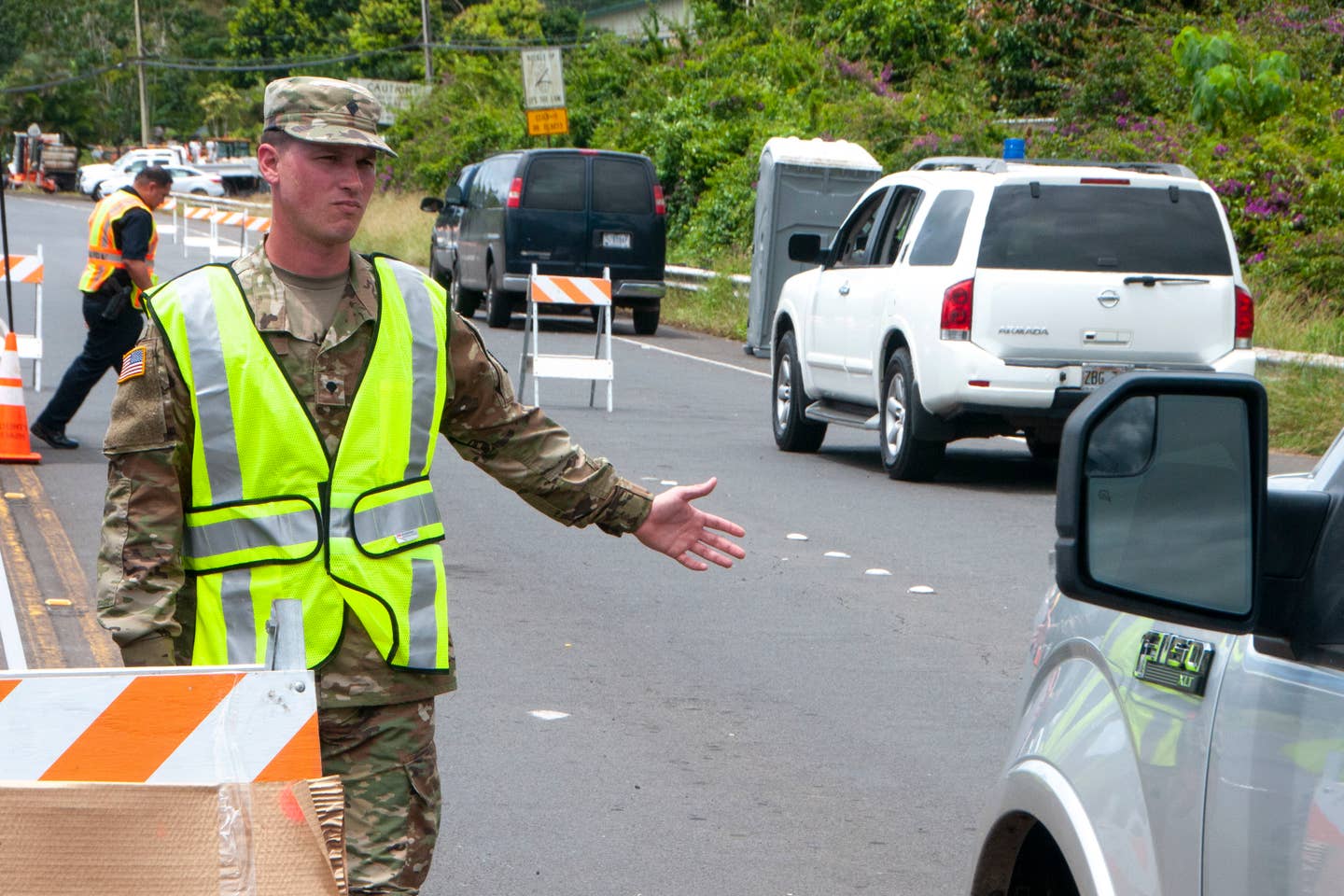 Spc. Donavan Wills, Bravo Co., 227th Brigade Engineer Battalion, directs traffic May 12, 2018 in response to the volcano eruption, at Leilani Estates, Pahoa, Hawaii.