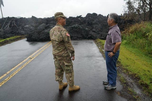 Brig. Gen. Kenneth Hara, Joint Task Force 5-0 commander, and Hawaii Governor David Ige examine an area in Leilani Estates where lava over ran the road, May 08, 2018, Pahoa Hawaii.