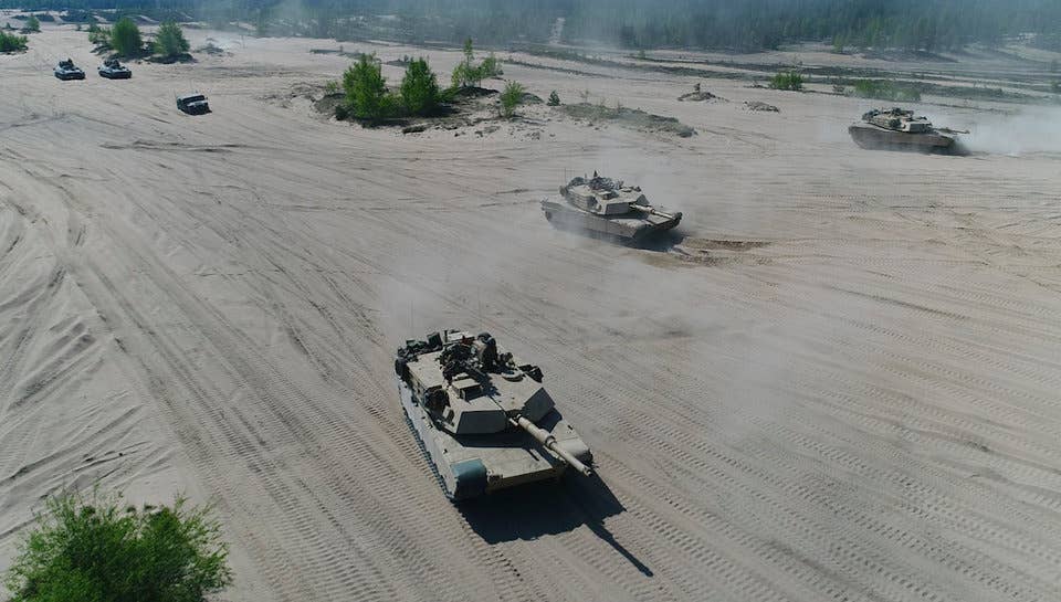 Marines with Bravo Company, 4th Tanks Battalion, drive the M1A1 Abrams tanks during a live-fire exercise as part of Exercise Arrow 18 in Pohjankangas Training Area near Kankaanpaa, Finland, May 16, 2018.
