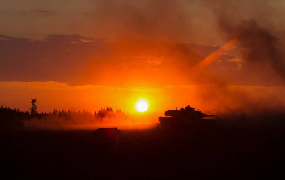 Marines with Bravo Company, 4th Tanks Battalion, fire an M1A1 Abrams tank during a low-light, live-fire exercise as part of Exercise Arrow 18 in Pohjankangas Training Area near Kankaanpaa, Finland, May 16, 2018.