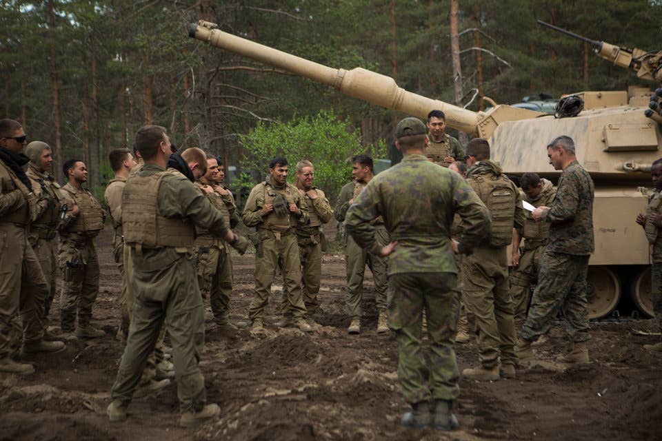 Marines with Bravo Company, 4th Tanks Battalion, review the scheme of maneuver for a live-fire exercise as part of Exercise Arrow 18 in Pohjankangas Training Area near Kankaanpaa, Finland, May 16, 2018.