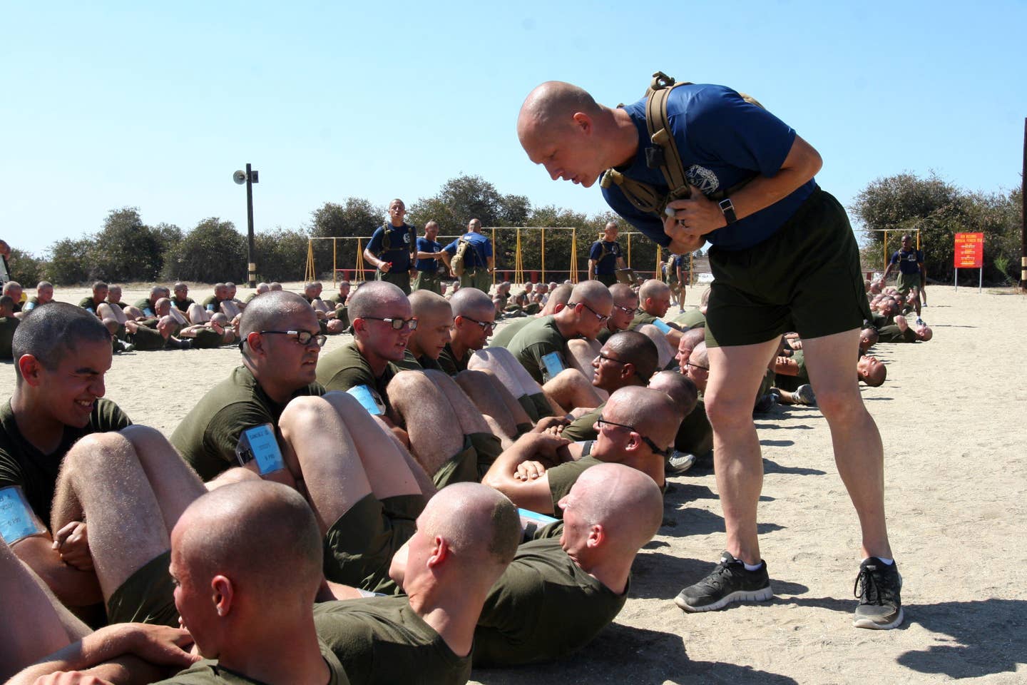 Drill instructors with Company I, 3rd Recruit Training Battalion, encourage recruits to push their limits as they finish the final part of the initial physical fitness test aboard Marine Corps Recruit Depot San Diego.<br>(Photo by Marine Lance Cpl. Bridget M. Keane)