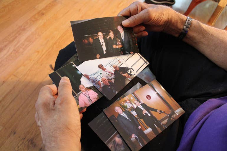 Ralph Stepney holds photos from a cruise he took to Bermuda with West and Hundt. Stepney put the photos into a keepsake album that he keeps at their home.
