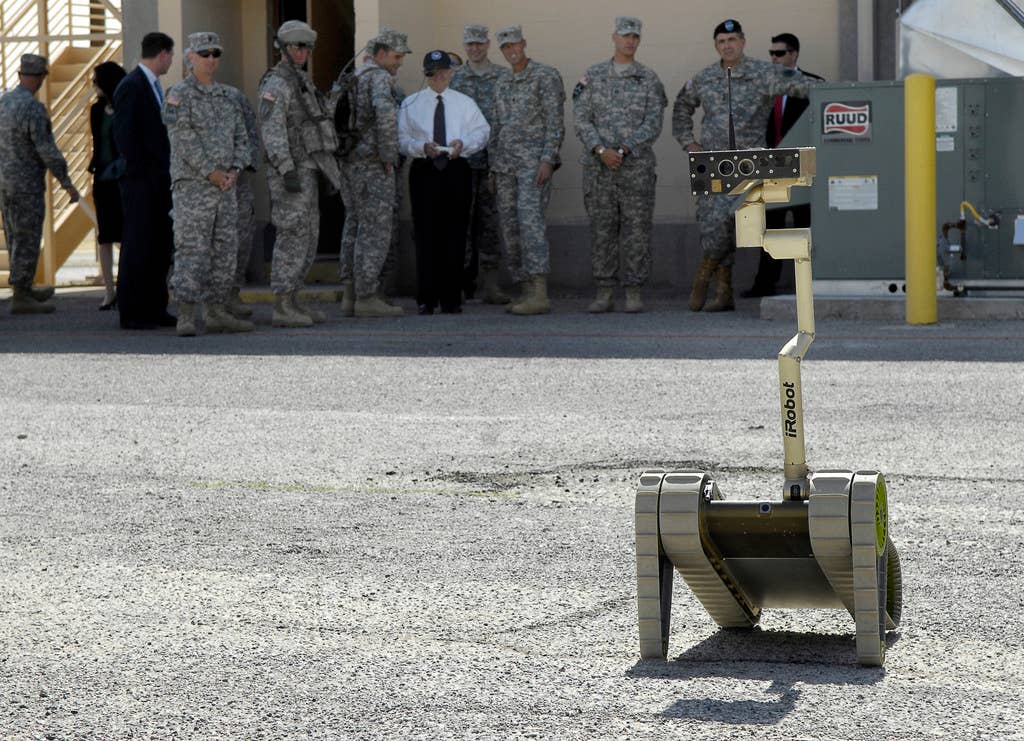Secretary of Defense Robert M. Gates learns how to operate an unmanned ground vehicle.