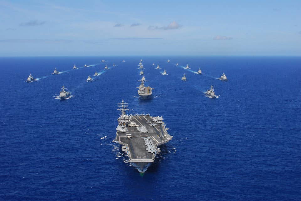 The aircraft carrier USS Ronald Reagan (CVN 76) transits the Pacific Ocean with ships assigned to Rim of the Pacific (RIMPAC) 2010 combined task force as part of a photo exercise north of Hawaii.