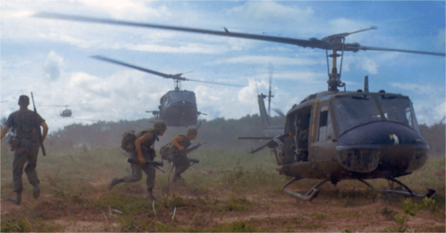 U.S. troops load up on a Huey during the Vietnam War.