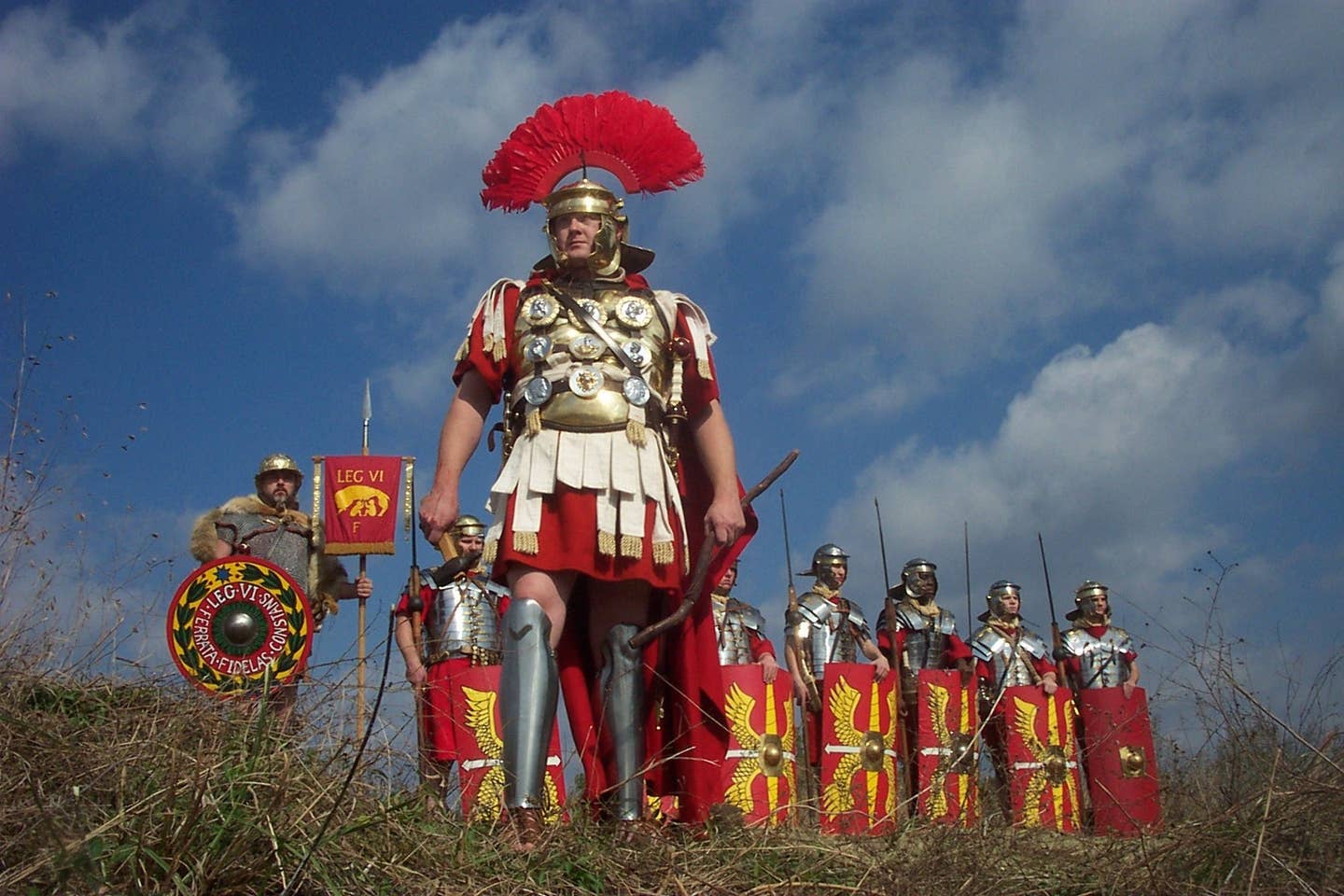 A Roman soldier proudly stands in front of his men. (Public domain)