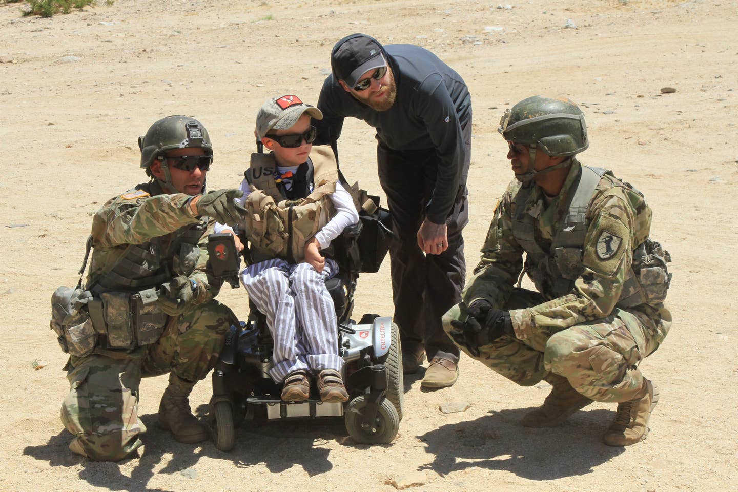 The 11th Armored Cavalry Regiment Troopers explain building clearance drills to Ethan Larimer, 11th ACR Honorary Blackhorse Trooper, and Daniel Larimer, Ethan's father and former Blackhorse Trooper.