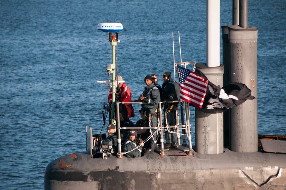 Officers and crew on the Seawolf-class fast-attack submarine USS Jimmy Carter looks on as the sub transits the Hood Canal on its way home to Naval Base Kitsap-Bangor, September 11, 2017.