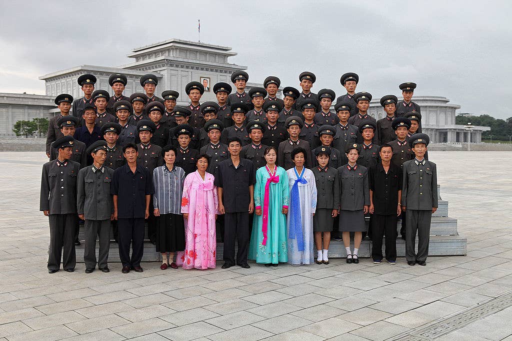 North Koreans posing for a photo.