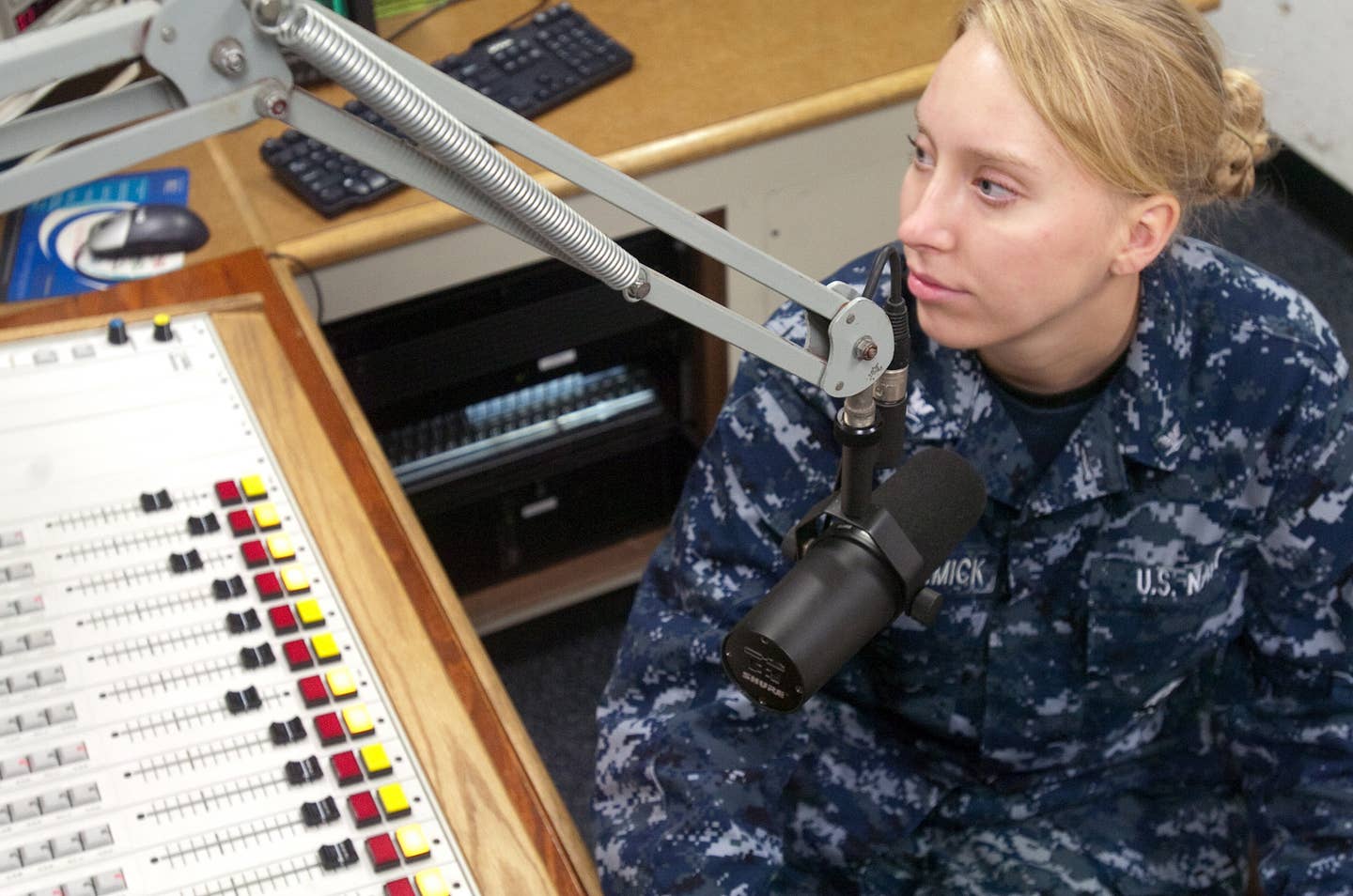 Radio GTMO personality, DJ Stacks, Petty Officer 3rd Class Heidi McCormick, pieces together her classic rock radio program, Jan. 10. McCormick is one of four DJs at the station who put together a total 21 local shows for the Guantanamo Bay community.