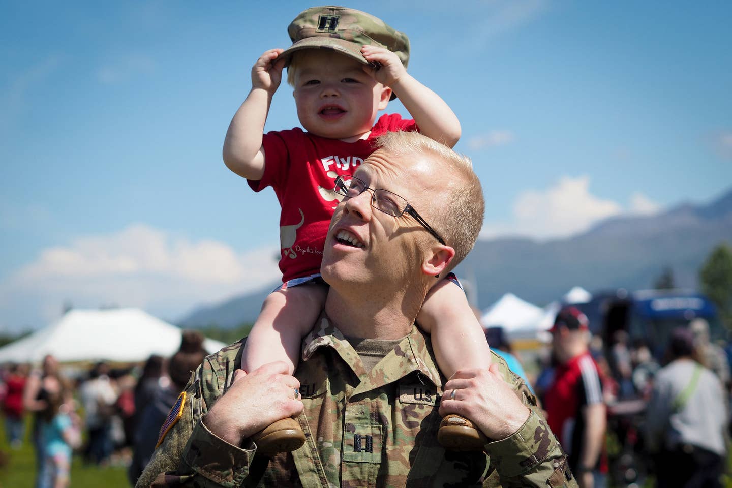 Army Capt. Ben Russell, carries his son Todd, 18-months-old, on his shoulders.