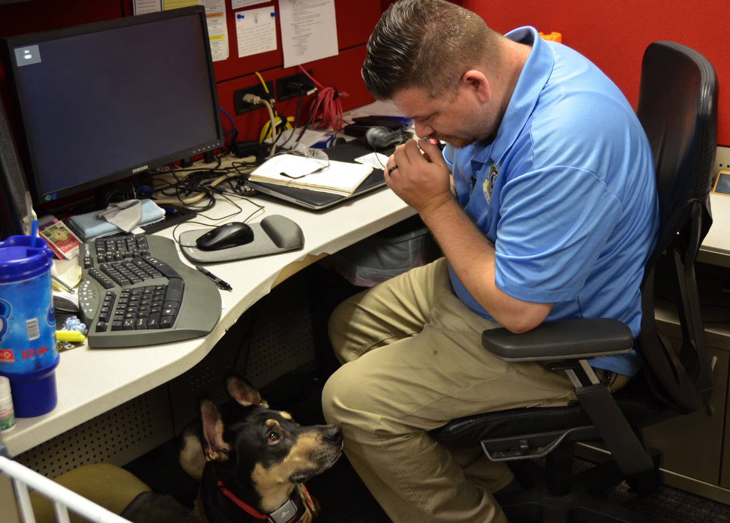 Ryan Kaono, a support agreement manager with the Air Force Installation and Mission Support Center, takes a moment to breath while his service dog Romeo assesses the situation.