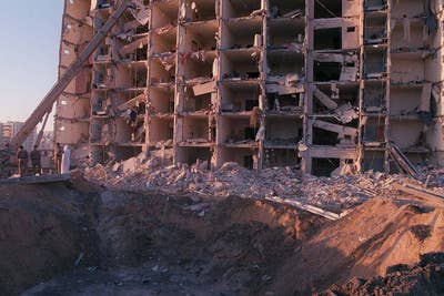 U.S. and Saudi military personnel survey the damage to Khobar Towers caused by the explosion of a fuel truck outside the northern fence of the facility on King Abdul Aziz Air Base near Dhahran, Saudi Arabia, at 2:55 p.m. EDT, Tuesday, June 25, 1996.