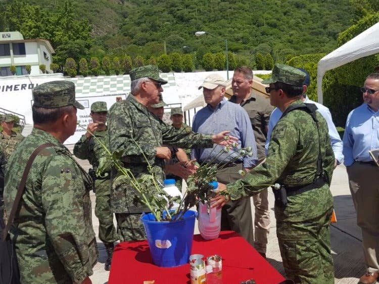 John Kelly, the Homeland Security secretary at the time (in the blue shirt in the center), in Mexico's Guerrero state in July 2017.