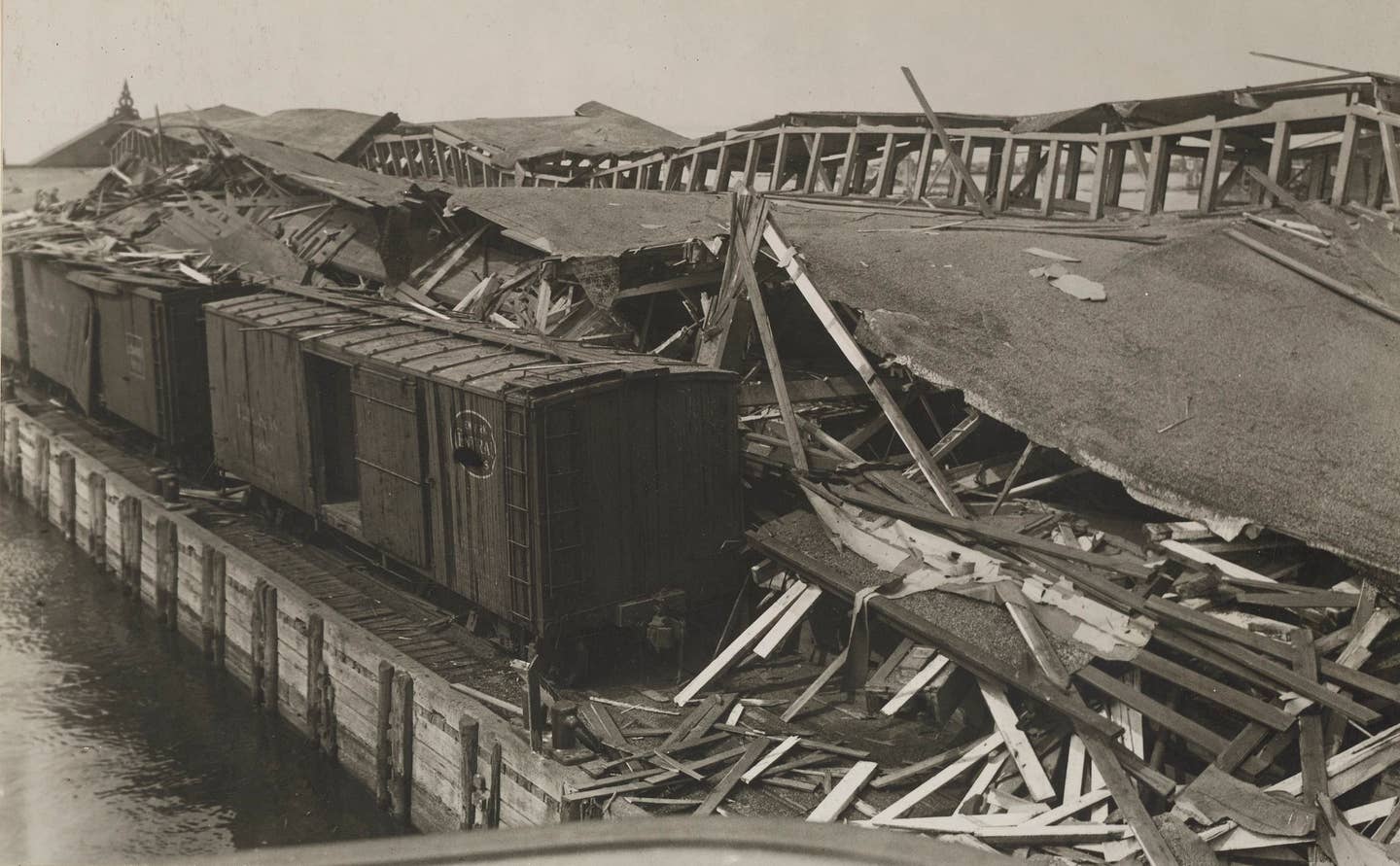 View of the debris of the Lehigh Valley pier wrecked by an explosion of munitions on Black Tom Island, New Jersey. Five dead and $25,000,000 worth ($500,000,000 in 2018) of property destroyed.