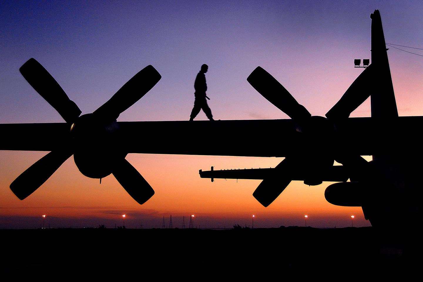 Tech. Sgt. Shane Kerns, 386th Expeditionary Aircraft Maintenance Squadron expediter, walks the wing of an EC-130 Compass Call aircraft while conducting a pre-flight check at an air base in Southwest Asia.