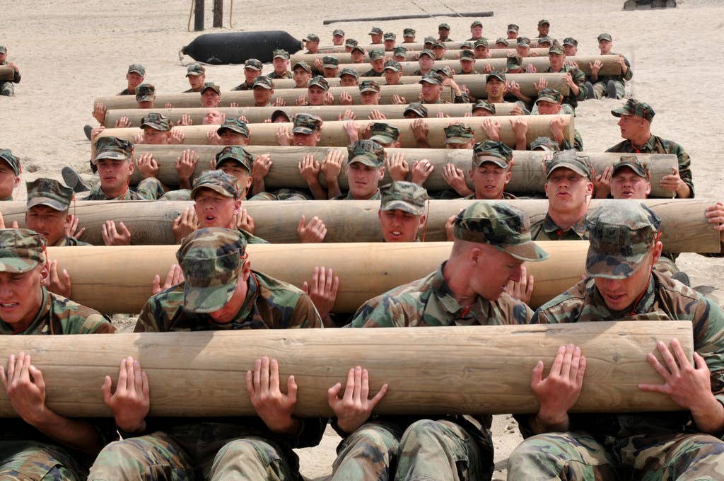 First Phase Basic Underwater Demolition/SEALs (BUD/S) candidates use teamwork to perform physical training exercises with a 600 pound log.