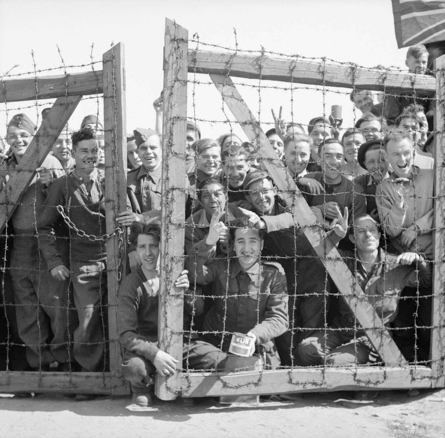 POWs at Stalag 11B at Fallingbostel in Germany welcome their liberators, 1945.