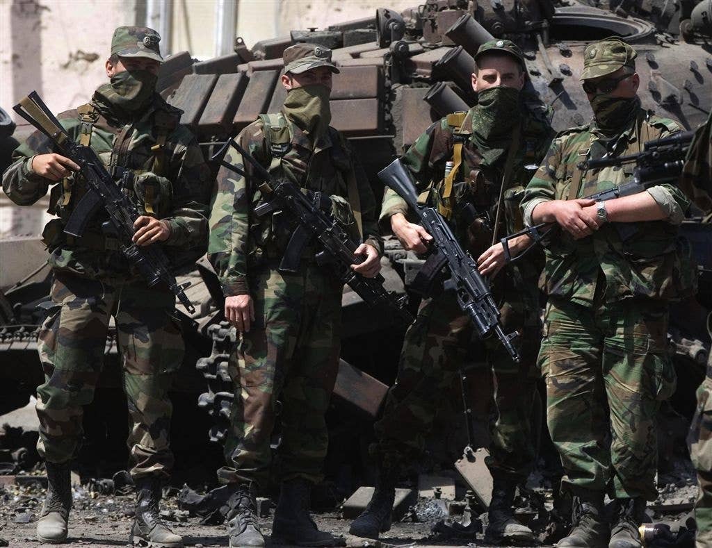 spetsnaz special operations unit stand with their weapons at the ready