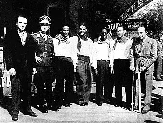 Something you don't see every day: four black men, a Jewish man, and a Gypsy all hanging out with a prominent Nazi Luftwaffe officer.