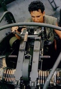 A machine gunner on a Patrol Boat River with his two machine guns.<br>(U.S. Navy)