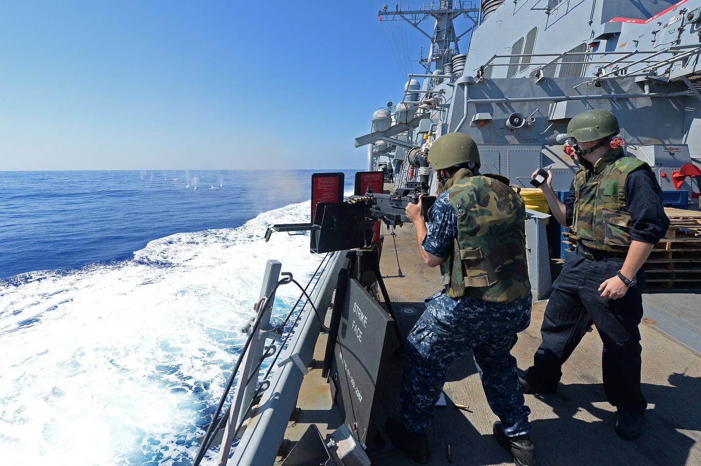sailors firing .50 cal on USS Cole