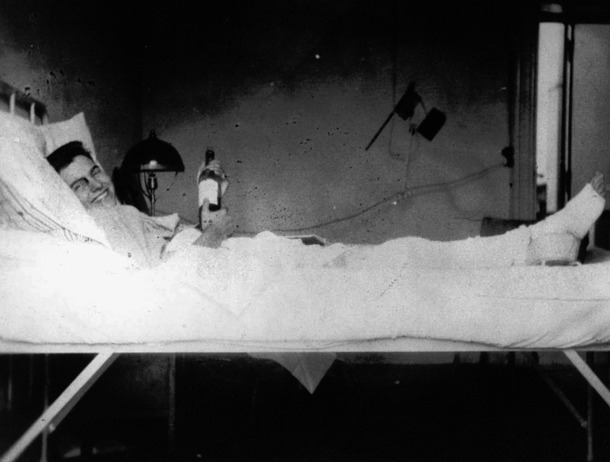 Hemingway recovering from his wounds in a World War I hospital with a bottle of stuff that can "cure everything." The afternoon would have to wait. (Public domain)